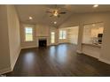 Open-concept living room features a fireplace, ceiling fan and beautiful views of the backyard at 71 Royal Ave, Selma, NC 27576
