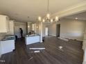 Spacious living room showcasing modern lighting, hardwood floors, and an open layout at 71 Royal Ave, Selma, NC 27576