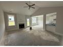 Bright living room featuring a fireplace, large windows, and an open concept layout at 71 Royal Ave, Selma, NC 27576