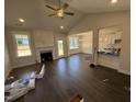 Open-concept living room with fireplace and adjacent kitchen and dining area at 71 Royal Ave, Selma, NC 27576