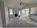 Open-concept living room features a fireplace, large windows, and an adjoining dining area, perfect for entertaining at 71 Royal Ave, Selma, NC 27576