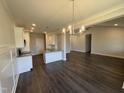 Open-concept living room features a view of the kitchen and backyard dining area at 71 Royal Ave, Selma, NC 27576