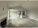Open-concept living area with a fireplace, high ceilings, and seamless flow into the kitchen, ideal for modern living at 71 Royal Ave, Selma, NC 27576