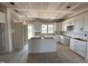 Modern kitchen with white cabinets, a center island, and a window above the sink at 76 Royal Ave, Selma, NC 27576