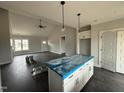 Spacious kitchen with island, pendant lighting, and modern appliances at 76 Royal Ave, Selma, NC 27576
