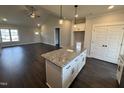 Eat-in kitchen features granite counters, white cabinets, stainless appliances, and hardwood floors at 76 Royal Ave, Selma, NC 27576
