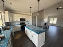 Open kitchen featuring white cabinets, modern appliances, and large island at 76 Royal Ave, Selma, NC 27576
