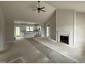 Bright, open-concept living room features a fireplace and leads into the kitchen area at 76 Royal Ave, Selma, NC 27576