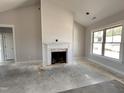 Cozy living room featuring shiplap, fireplace, and a large window at 76 Royal Ave, Selma, NC 27576