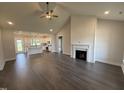 Spacious open-concept living area flows into the kitchen, with wood floors, high ceilings, and fireplace at 76 Royal Ave, Selma, NC 27576