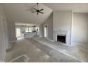 Bright living room with vaulted ceiling, modern ceiling fan, and fireplace with ship lap accent wall at 76 Royal Ave, Selma, NC 27576