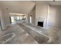 Open-concept living room with fireplace and eat in kitchen at 76 Royal Ave, Selma, NC 27576