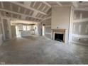 Spacious living room featuring a fireplace and open floor plan to the kitchen at 76 Royal Ave, Selma, NC 27576
