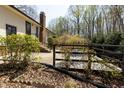 Backyard area with a patio, lush landscaping, and mature trees offering shade and privacy at 7605 Mine Valley Rd, Raleigh, NC 27615