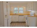 Bright kitchen featuring white appliances, wooden countertops, and a window providing natural light at 7605 Mine Valley Rd, Raleigh, NC 27615