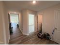 Inviting hallway with wood-look flooring leading to various rooms of the house at 8 W Emily Gardens Dr, Selma, NC 27576