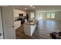 Modern kitchen with stainless steel appliances, granite countertops, and a center island at 8 W Emily Gardens Dr, Selma, NC 27576