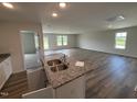 Open-concept space featuring a kitchen with granite countertops and stainless steel sink at 8 W Emily Gardens Dr, Selma, NC 27576
