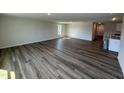 Open-concept living room with hardwood flooring, natural light, and neutral paint, creating a welcoming atmosphere at 8 W Emily Gardens Dr, Selma, NC 27576
