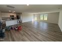 Open-concept living room and kitchen with wood flooring and plenty of natural light at 8 W Emily Gardens Dr, Selma, NC 27576