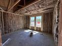 Unfinished bedroom with insulation in the walls and two windows, ready for final touches and personalization at 8 W Emily Gardens Dr, Selma, NC 27577