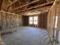 Unfinished bedroom with insulation in the walls and two windows, ready for final touches and personalization at 8 W Emily Gardens Dr, Selma, NC 27577