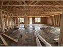 Spacious interior framing of new home features high ceilings, stud walls, concrete floors, and views of the exterior at 8 W Emily Gardens Dr, Selma, NC 27577