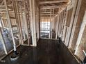 Interior framing of new home featuring wood studs, plumbing fixtures, concrete floors, and views of the exterior at 8 W Emily Gardens Dr, Selma, NC 27577