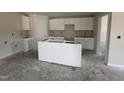 Unfinished spacious kitchen featuring white cabinets, center island, and ample space for customization at 8 W Emily Gardens Dr, Selma, NC 27577