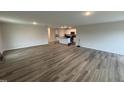 Open-concept living room featuring wood-look floors, recessed lighting and an island with a sink at 8 W Emily Gardens Dr, Selma, NC 27577