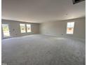 Bright and airy living room with plenty of natural light streaming through the double set of windows at 8 W Emily Gardens Dr, Selma, NC 27577