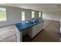 Stylish kitchen island featuring a sink and ample cabinet space, perfect for meal prep and entertaining at 82 W Emily Gardens Dr, Selma, NC 27576