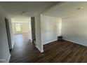 Bright living room featuring new flooring, fresh paint, and ample natural light from the window at 82 W Emily Gardens Dr, Selma, NC 27576