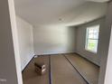 Bright living room featuring large windows and neutral paint, perfect for relaxation and entertaining at 82 W Emily Gardens Dr, Selma, NC 27576
