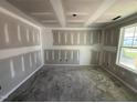 Unfinished bedroom features a window and a smooth, level floor at 82 W Emily Gardens Dr, Selma, NC 27577