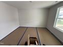 A bedroom with covered floors, light walls, bright window and electrical plugs at 82 W Emily Gardens Dr, Selma, NC 27576