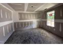 Unfinished bedroom showcasing natural light streaming through a window at 82 W Emily Gardens Dr, Selma, NC 27577