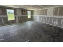 Spacious unfinished bedroom with natural light from the two double windows at 82 W Emily Gardens Dr, Selma, NC 27577