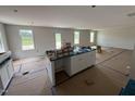 Open concept kitchen with white cabinets, a center island, and natural light at 82 W Emily Gardens Dr, Selma, NC 27576