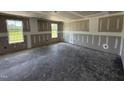 Unfinished living room with two windows providing ample natural light and an open floor plan at 82 W Emily Gardens Dr, Selma, NC 27577