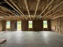 Unfinished living room features stud framing, insulation, and rear access at 82 W Emily Gardens Dr, Selma, NC 27577