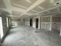 Open-concept living area displays drywall, several windows and doorway access to other rooms at 82 W Emily Gardens Dr, Selma, NC 27577