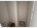Unfinished bathroom with a toilet flange, water lines, and a doorway at 83 W Emily Gardens Dr, Selma, NC 27576