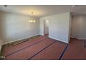 Unfurnished dining area with new flooring, a modern chandelier, and freshly painted light gray walls at 83 W Emily Gardens Dr, Selma, NC 27576