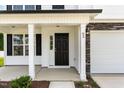 Close-up of front door with sidelight and stone accents, showcasing the home's entry at 83 W Emily Gardens Dr, Selma, NC 27576