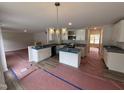 Eat-in kitchen boasts white cabinets, a large island, modern appliances, and beautiful granite countertops at 83 W Emily Gardens Dr, Selma, NC 27576