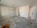 Unfinished living room featuring a chandelier and entryways at 83 W Emily Gardens Dr, Selma, NC 27576