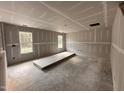 Bright living room under construction featuring drywall, and natural light from the two windows at 83 W Emily Gardens Dr, Selma, NC 27576