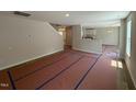 Spacious unfurnished living area with open floor plan, view of stairs, and access to the kitchen at 83 W Emily Gardens Dr, Selma, NC 27576