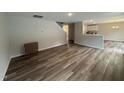 Open-concept living room area with wood flooring and a view to the kitchen at 83 W Emily Gardens Dr, Selma, NC 27576